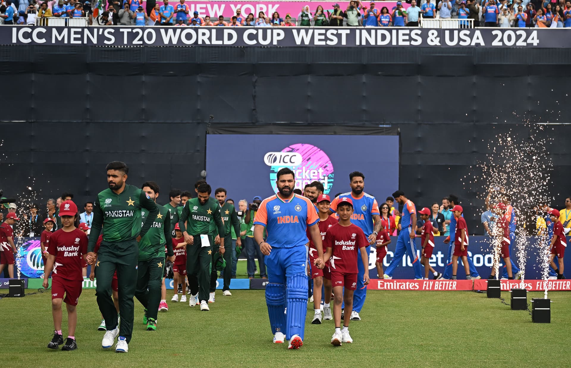 Babar Azam of Pakistan and Rohit Sharma of India take to the field during the ICC Men's T20 Cricket World Cup West Indies & USA 2024 match between India and Pakistan at Nassau County International Cricket Stadium