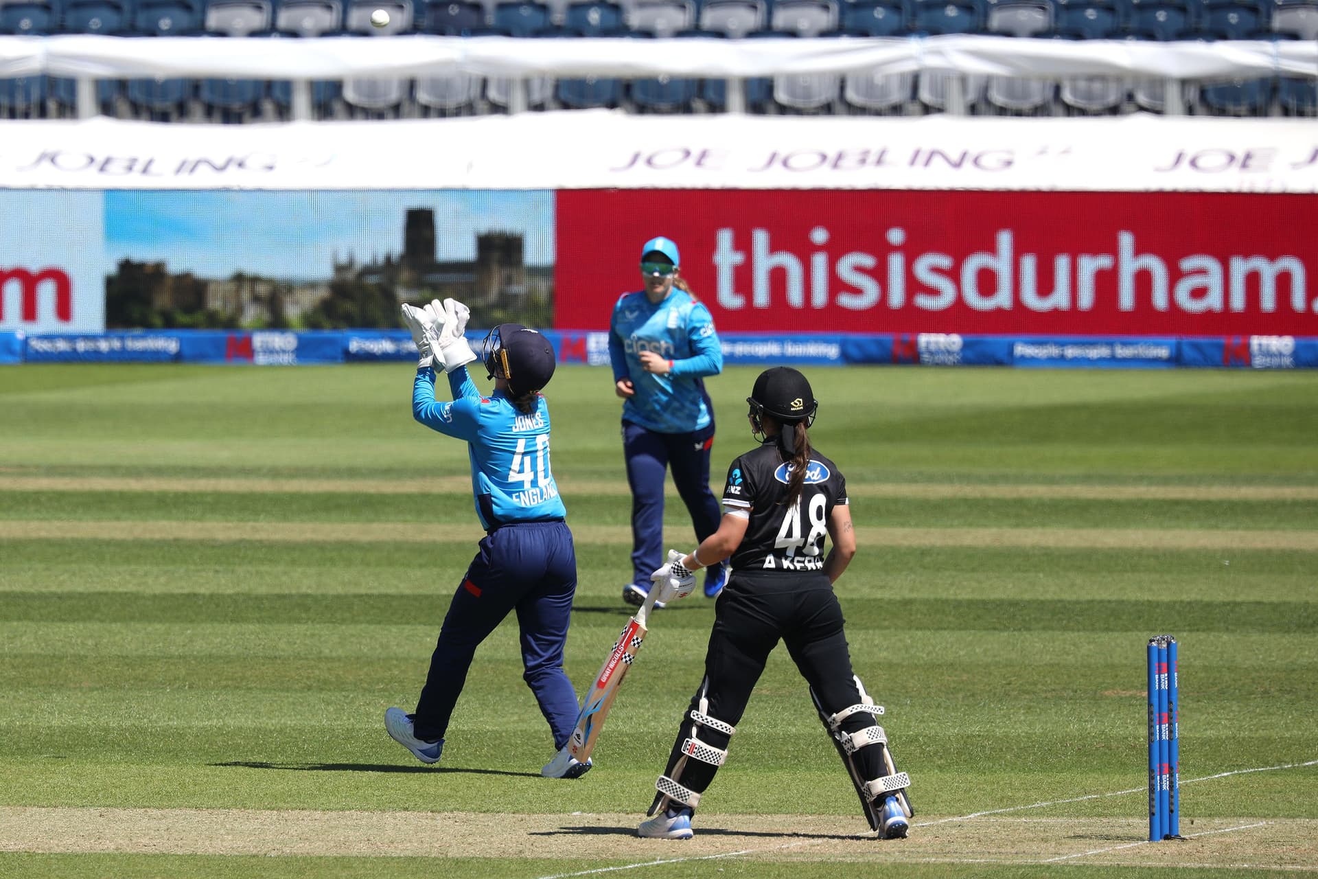Amy Jones of England is taking a catch to dismiss Amelia Kerr