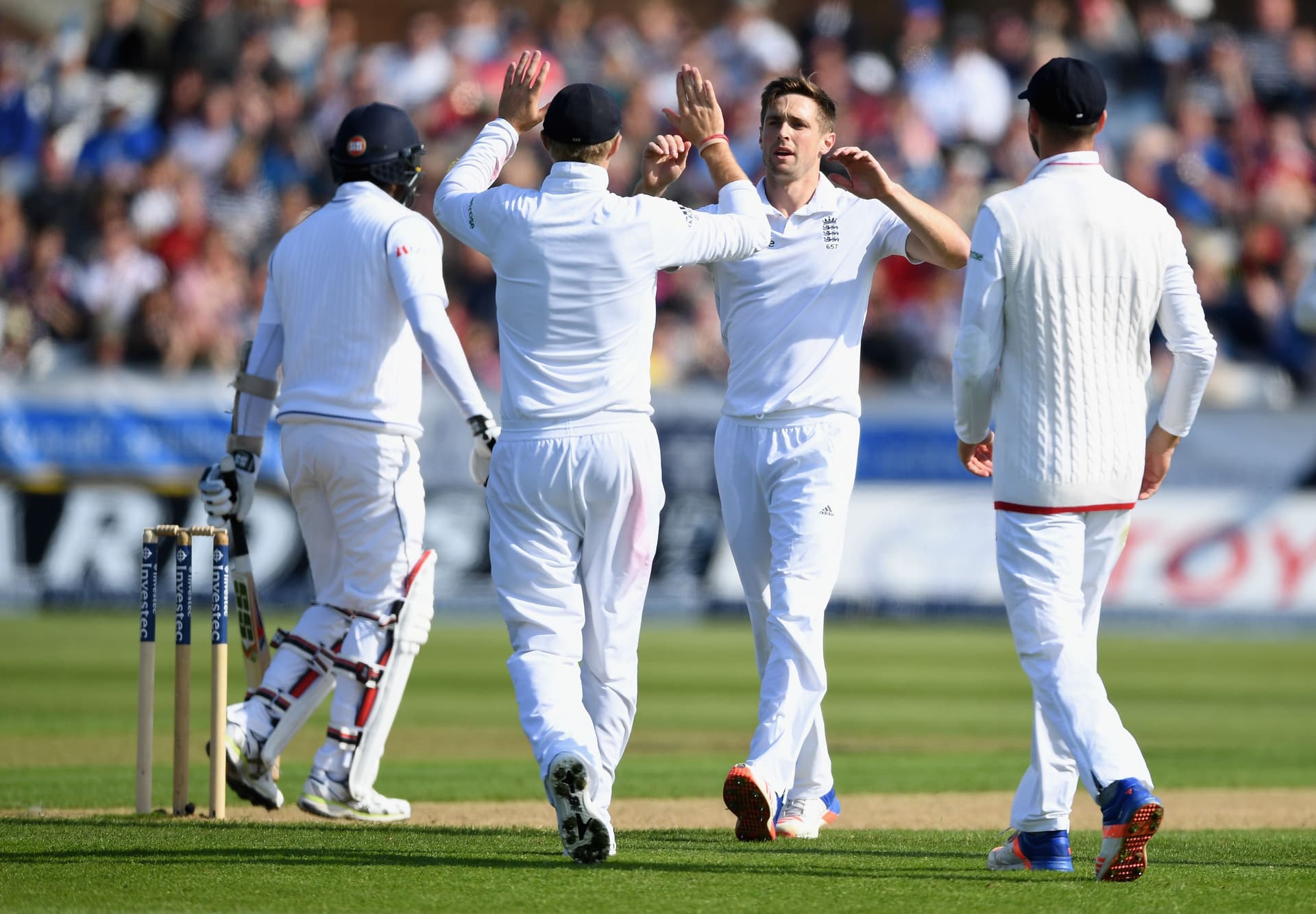 Chris Woakes of England celebrates with teammates after dismissing Angelo Mathews of Sri Lanka