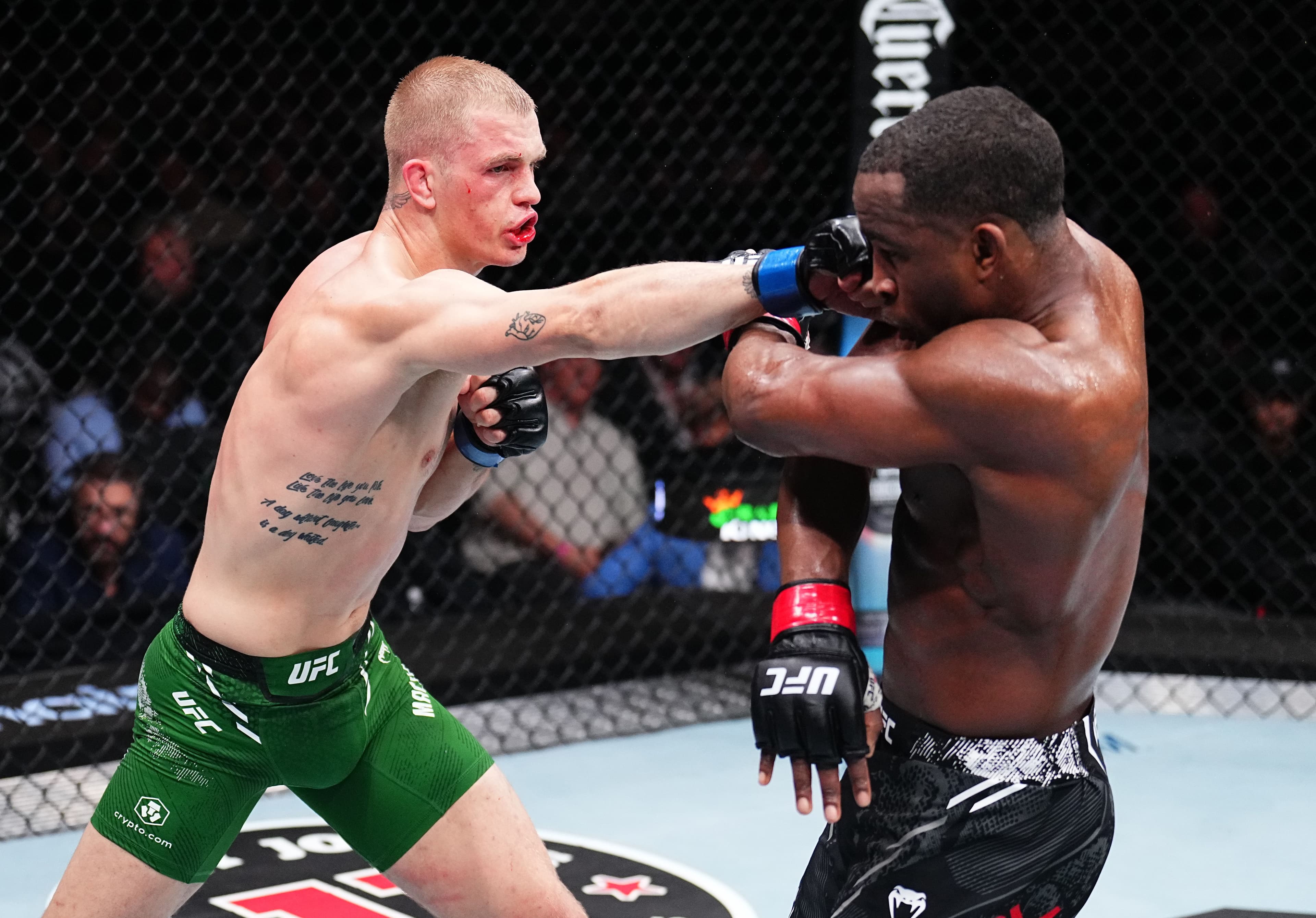 Ian Garry of Ireland punches Geoff Neal