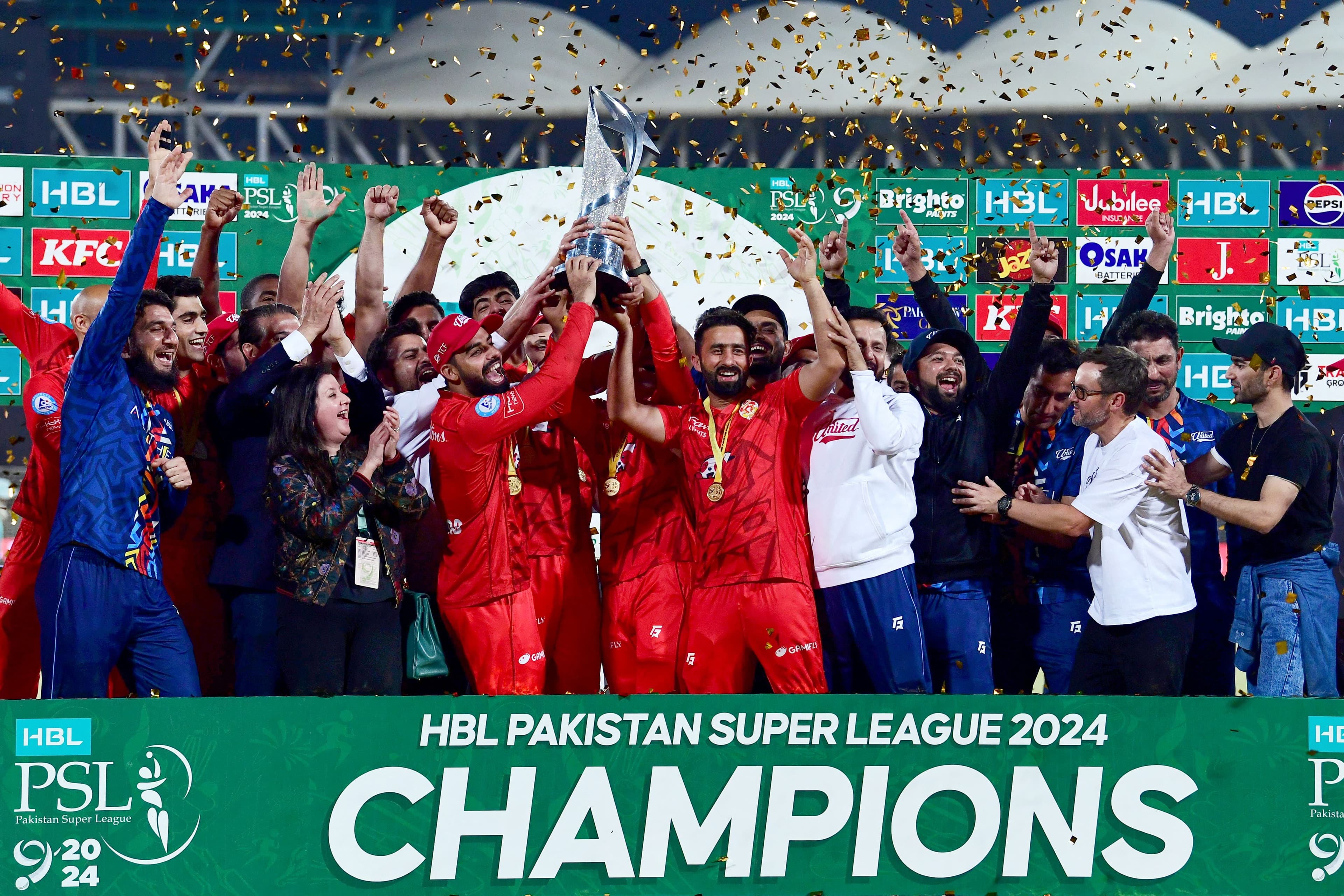 Islamabad United's players hold the Pakistan Super League (PSL) trophy