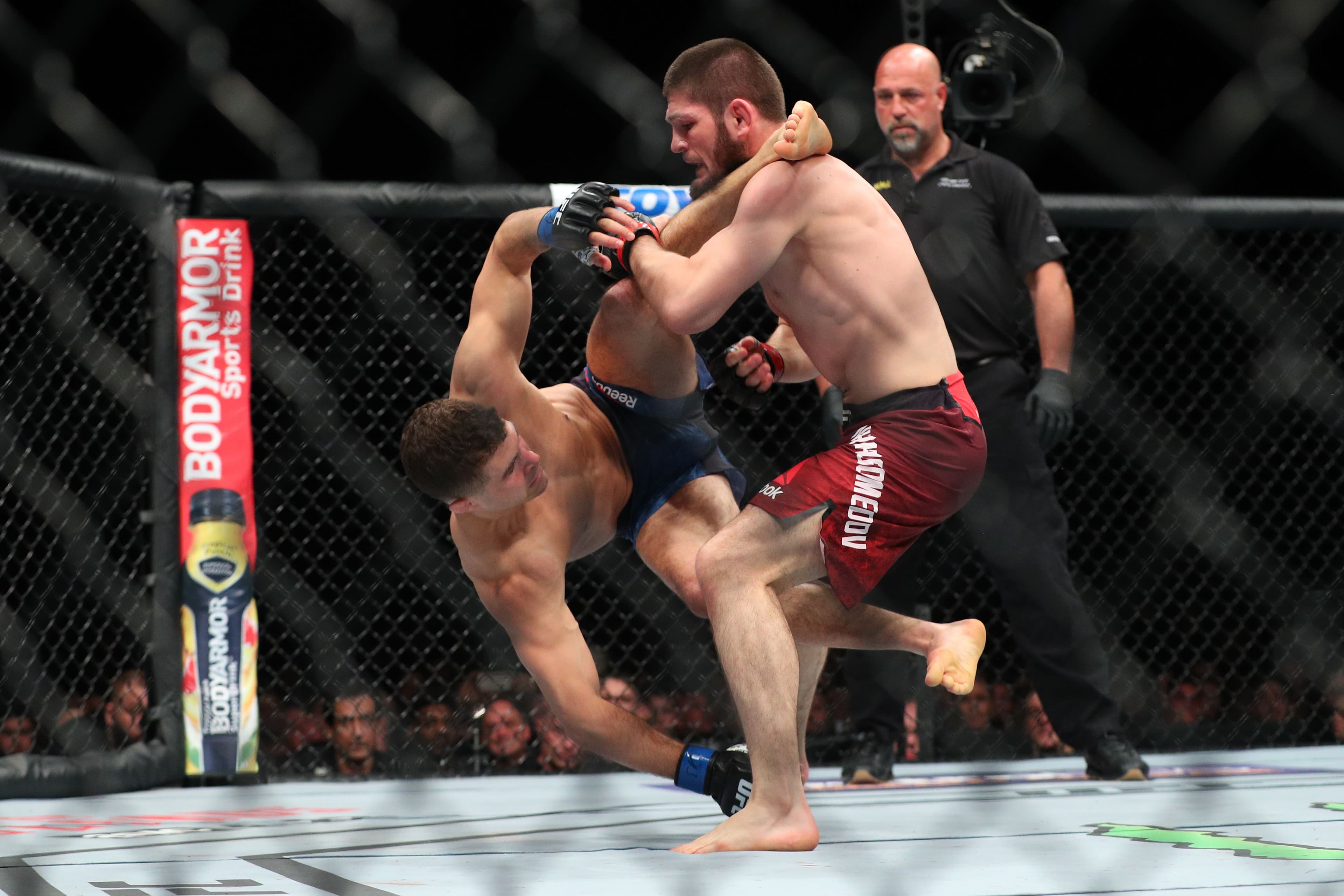 Khabib Nurmagomedov (R) attempts a takedown on Al Iaquinta