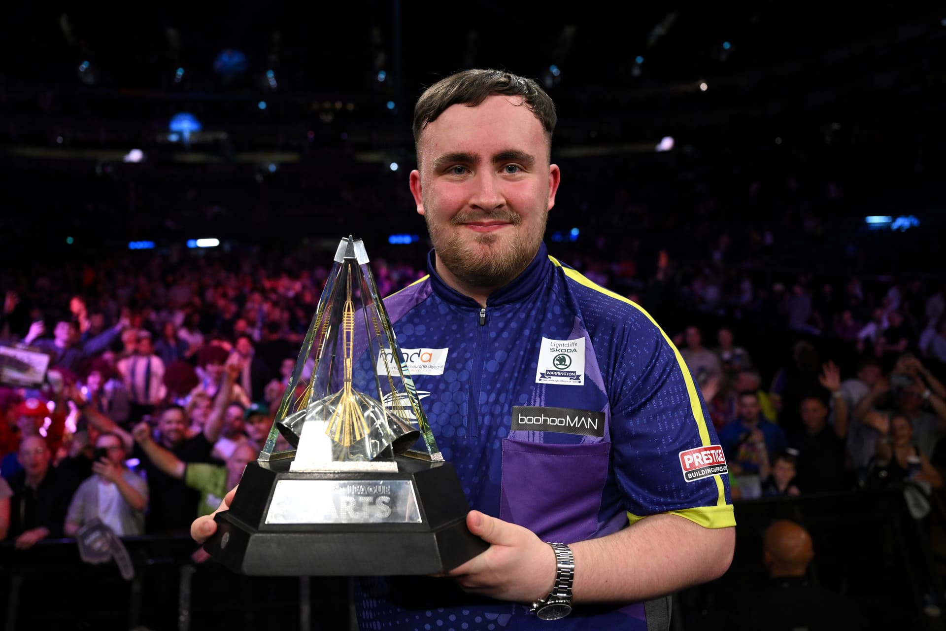Luke Littler of England celebrates with the trophy after winning the Final match