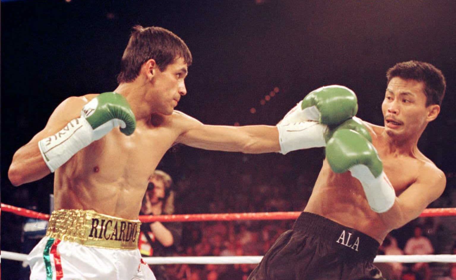 World Boxing Council strawweight champion Ricardo Lopez of Mexico (L) lands a left against challenger Ala Villamor of the Philippines