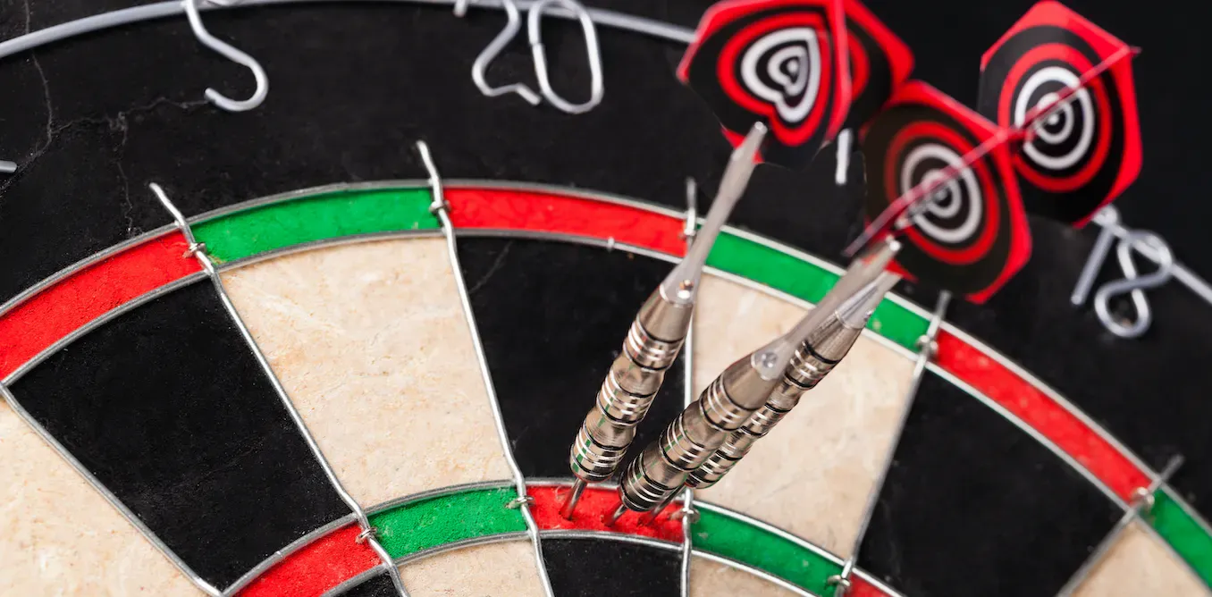 three darts on a board